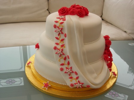 Drape and flowers wedding cake